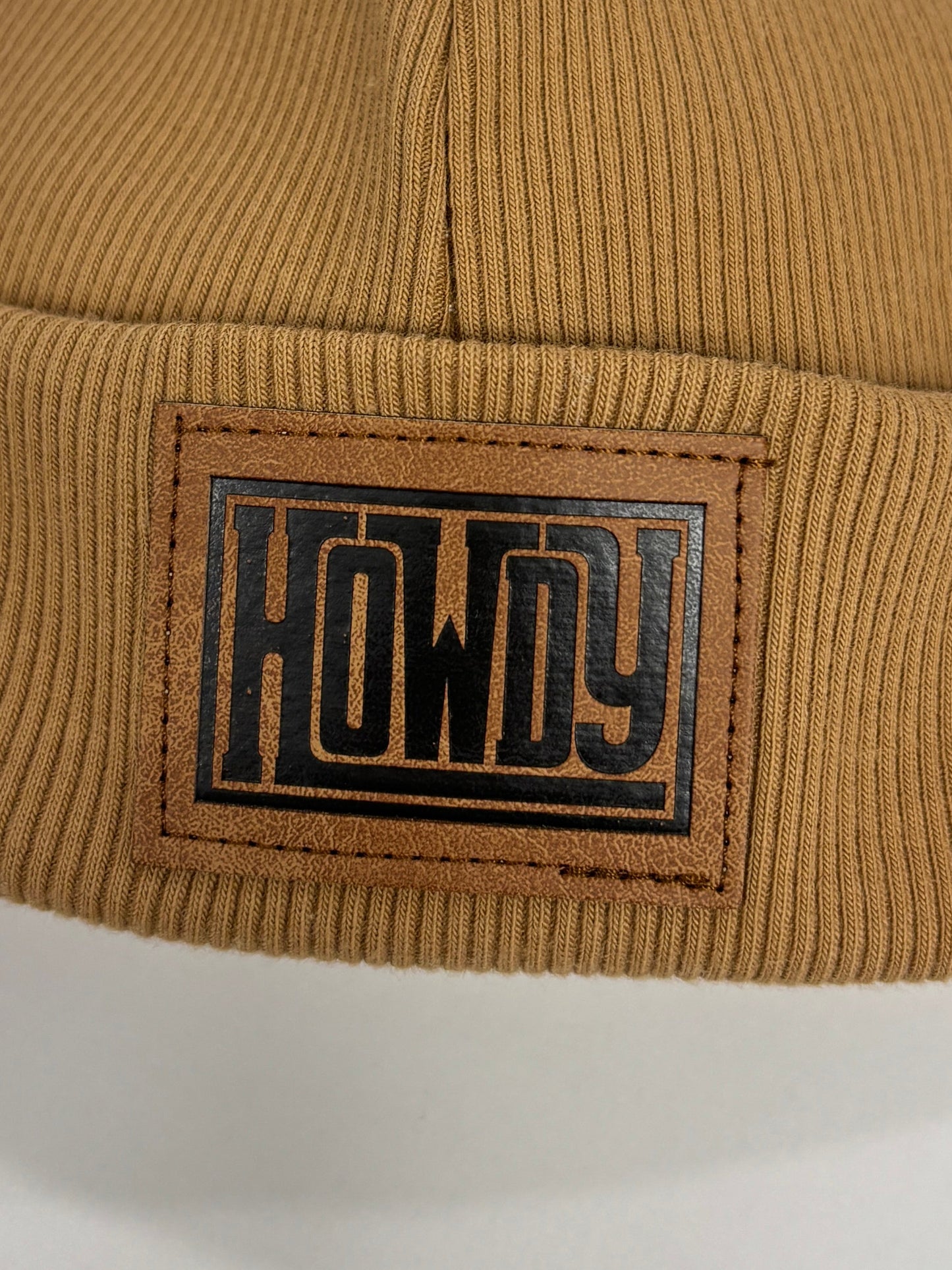 Brown beanie with a logo on a white background