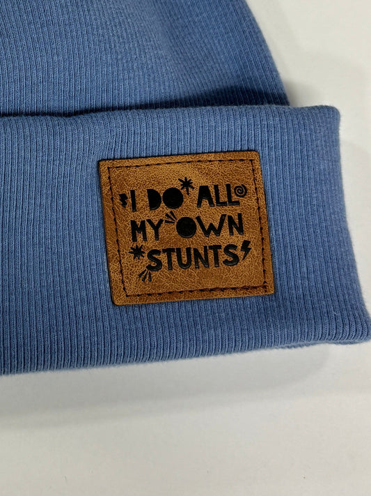 Blue knit beanie with a brown label on a white background