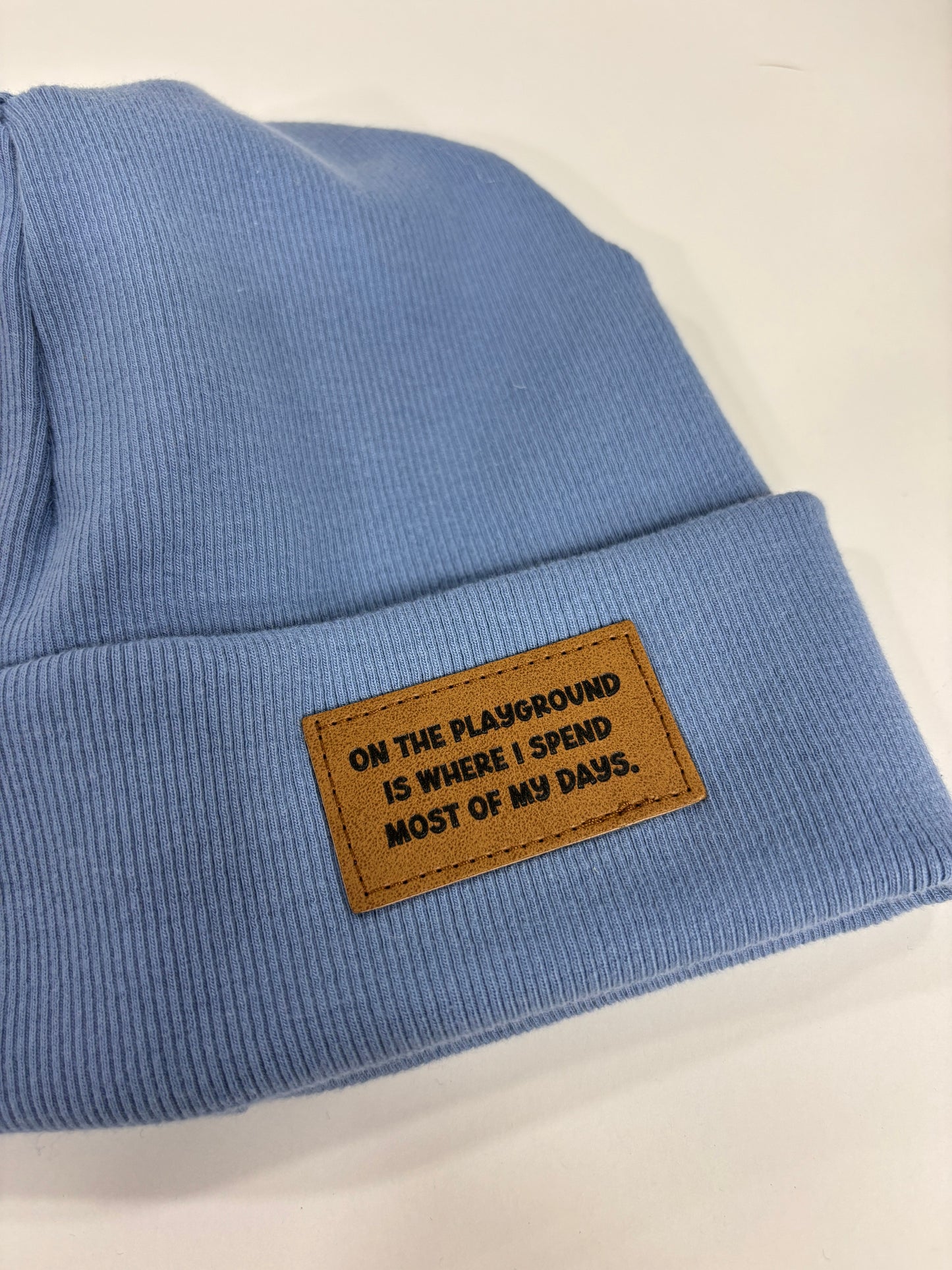 Blue fabric with a brown leather patch on a white background