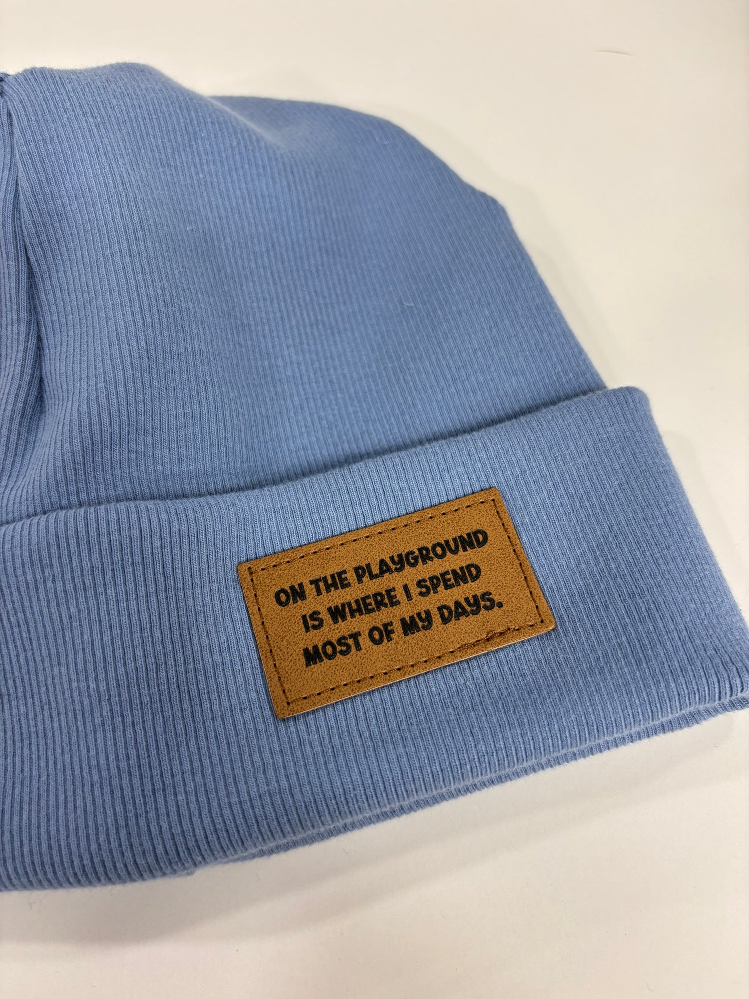 Blue fabric with a brown leather patch on a white background